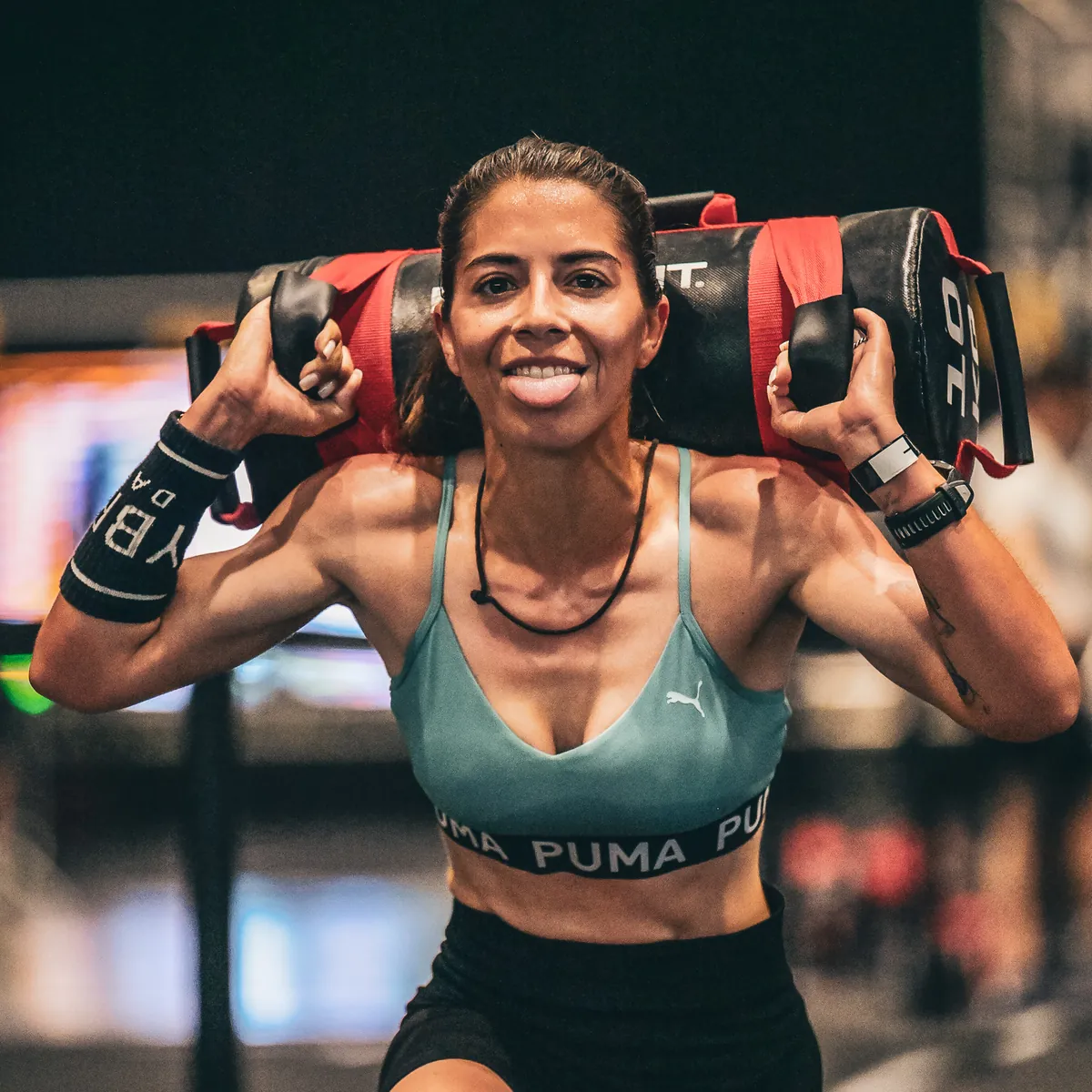 Athlete smiling on the sandbag carry